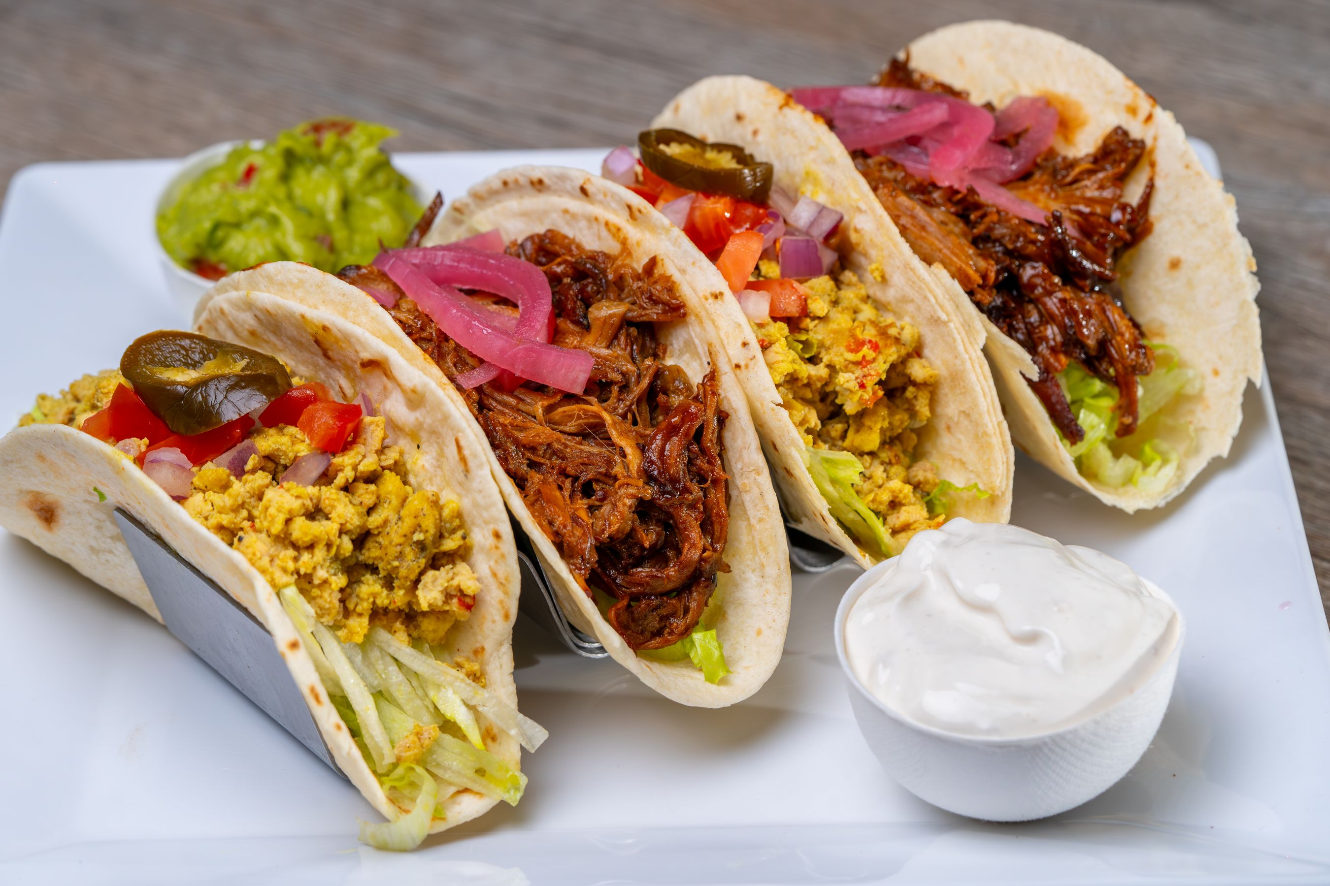 Warm plate of tacos with shredded meat and eggs, guacamole on the side — a hearty morning test bed.